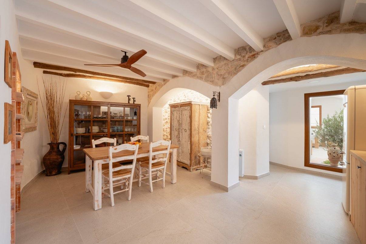 The dining room under stone arches, with the crockery dresser.