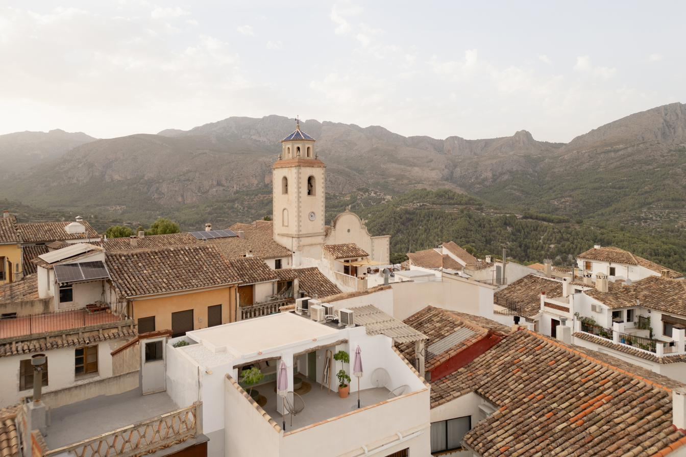 Benimantell from the air: rooftops, the bell tower and the Aitana range behind.