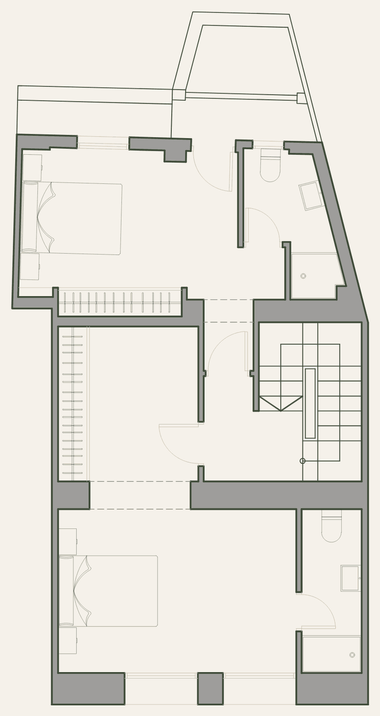 First-floor plan: two bedrooms with bathrooms and a balcony.