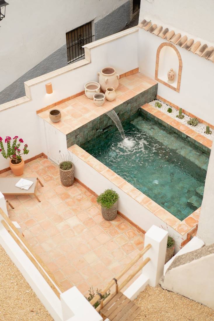 The courtyard from above: the pool with its spout, terracotta and pots.